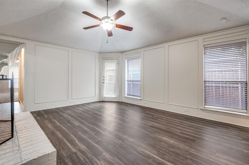 2118 Falcon Ridge Drive Carrollton, TX 75010 - Photo 3 of 18 an empty room with wooden floor and windows
