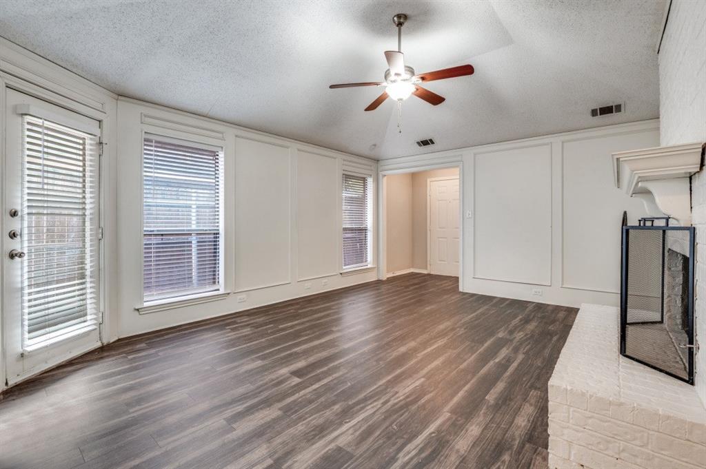2118 Falcon Ridge Drive Carrollton, TX 75010 - Photo 5 of 18 a view of an empty room with wooden floor and a window