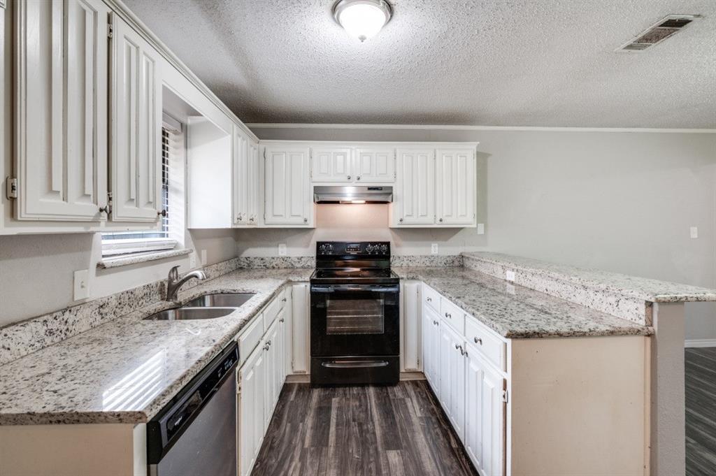 2118 Falcon Ridge Drive Carrollton, TX 75010 - Photo 8 of 18 a kitchen with a sink stove and cabinets