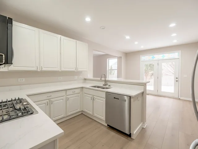 a kitchen with a sink stove and cabinets