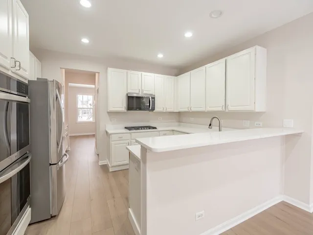 a kitchen with a sink stainless steel appliances and cabinets