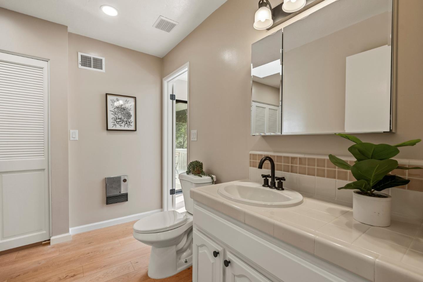 5152 Felter Road San Jose, CA 95132 - Photo 32 of 43 a bathroom with a sink a toilet and a mirror