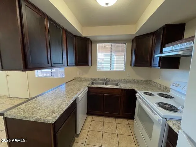 a kitchen with a stove a sink and a microwave