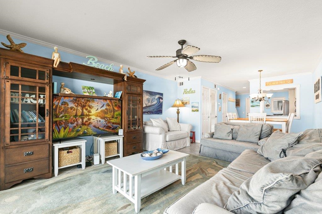 8550 A1A South, Unit 208 St. Augustine, FL 32080 - Photo 18 of 56 a living room with furniture a flat screen tv and a window