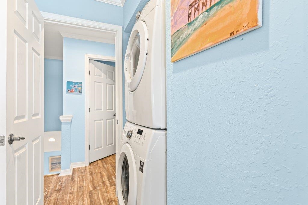 8550 A1A South, Unit 208 St. Augustine, FL 32080 - Photo 2 of 56 a view of a bedroom with wooden floor and white walls