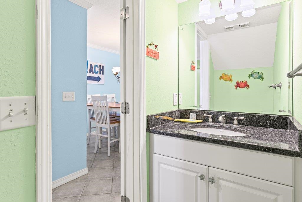 8550 A1A South, Unit 208 St. Augustine, FL 32080 - Photo 31 of 56 a bathroom with a granite countertop sink and a mirror