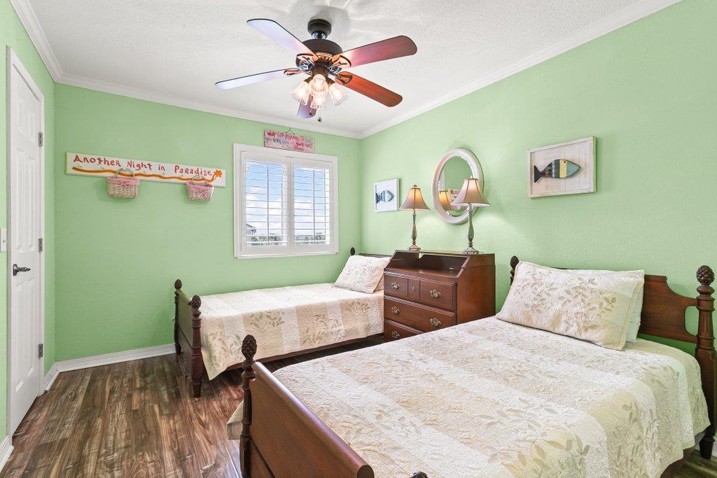 8550 A1A South, Unit 208 St. Augustine, FL 32080 - Photo 36 of 56 a bedroom with 2 bed and a chandelier