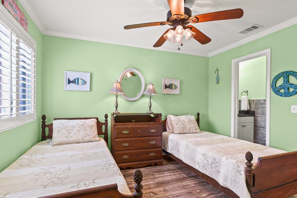 8550 A1A South, Unit 208 St. Augustine, FL 32080 - Photo 37 of 56 a bedroom with a bed and a chandelier