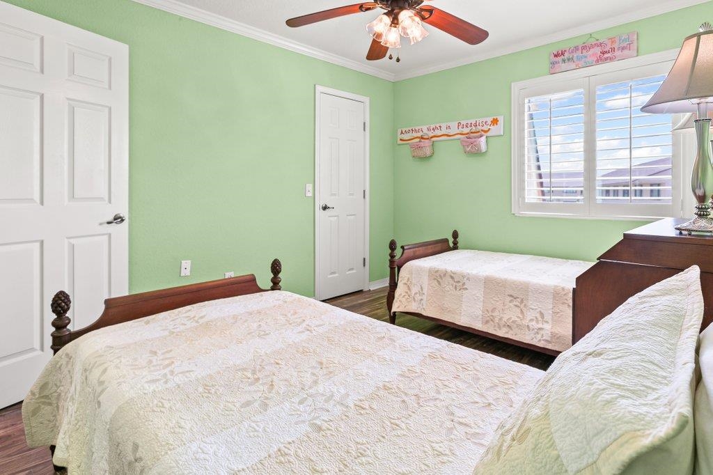 8550 A1A South, Unit 208 St. Augustine, FL 32080 - Photo 38 of 56 a bedroom with a bed and a chandelier