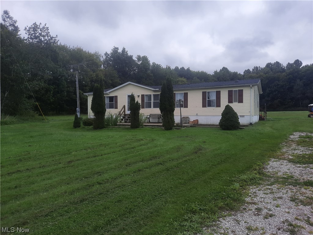 3973 Mill Road Dorset, OH 44032 - Photo 2 of 13 Manufactured / mobile home featuring a front lawn