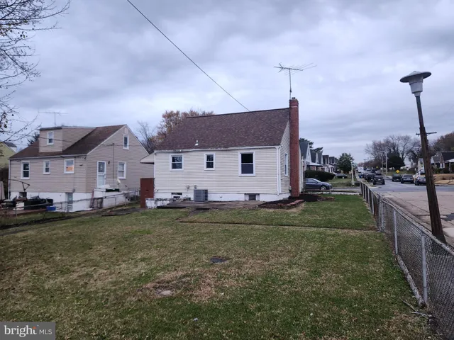 a view of a tennis ground with large trees
