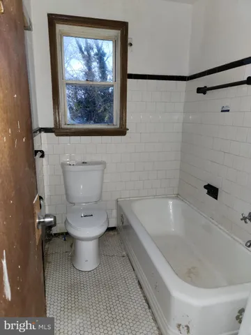 a bathroom with a toilet and a bathtub