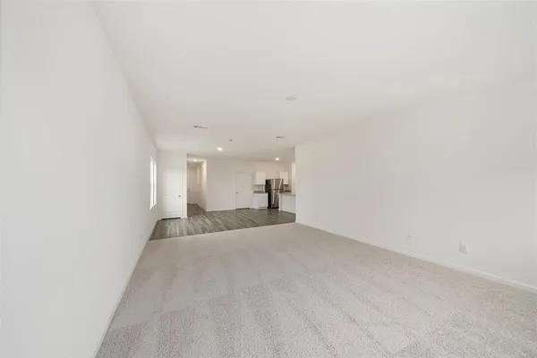 a view of a big room with closet and windows