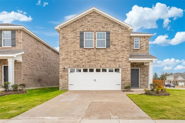 a front view of a house with a yard