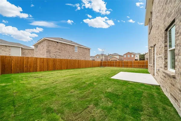 a view of an house with backyard space and balcony
