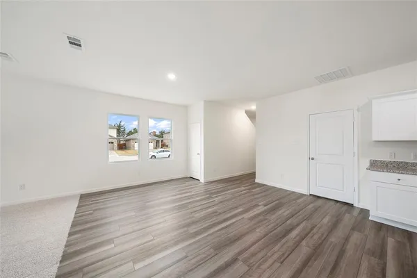 a view of a kitchen with wooden floor and a stove