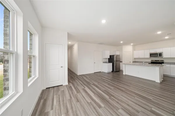a view of kitchen view with wooden floor and stainless steel appliances