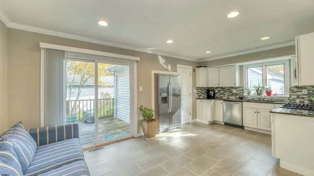 a large white kitchen with a large window