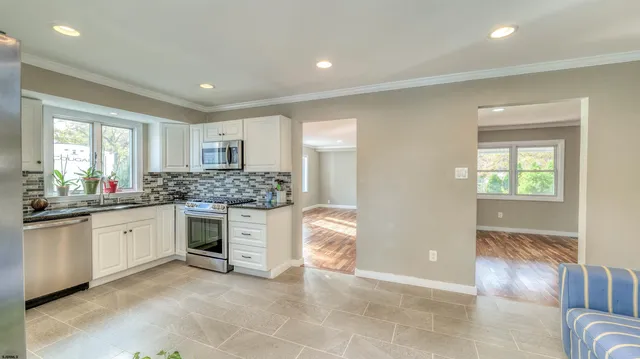 a kitchen with stainless steel appliances granite countertop a stove and a sink