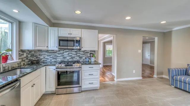 a kitchen with stainless steel appliances granite countertop a stove and a sink