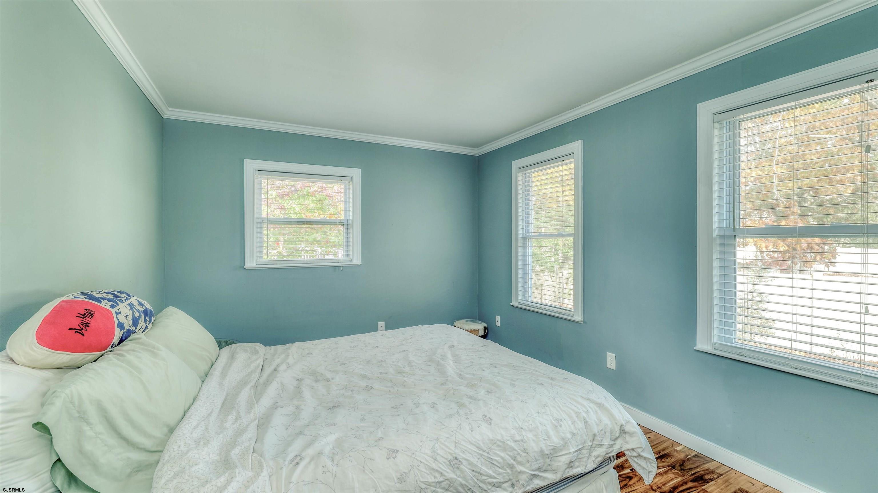 906 New Road Somers Point, NJ 08244 - Photo 25 of 32 a bedroom with a bed dresser and a window