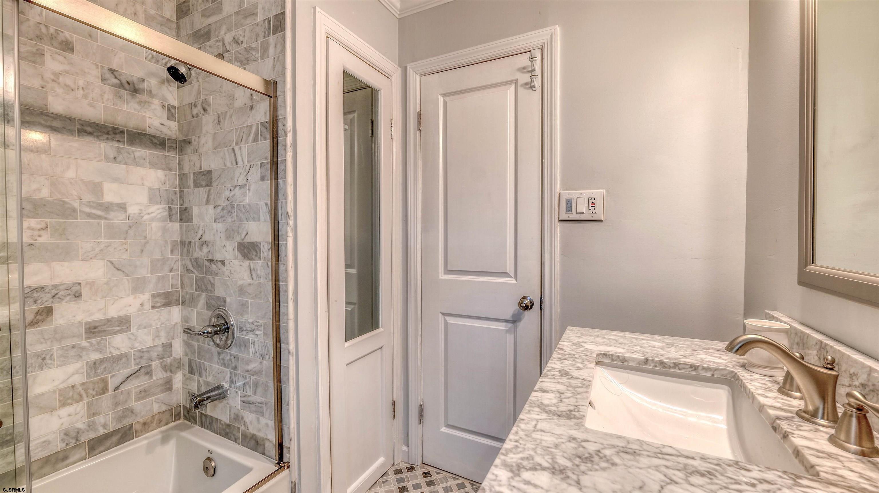 906 New Road Somers Point, NJ 08244 - Photo 29 of 32 a bathroom with a bathtub and a shower