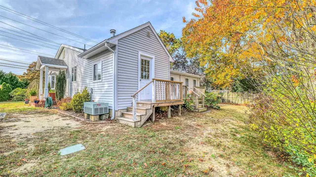 a view of a house with a yard and sitting area