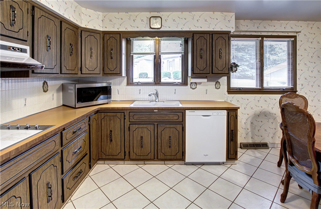 6013 Rousseau Drive Parma, OH 44129 - Photo 2 of 50 Kitchen with plenty of natural light, sink, dishwasher, and light tile flooring