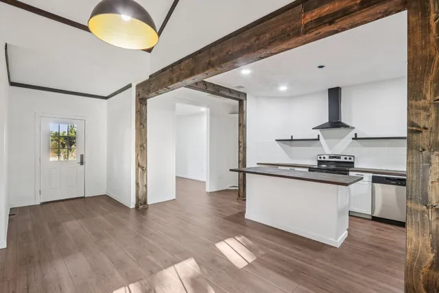 a kitchen with stainless steel appliances granite countertop a sink and a stove