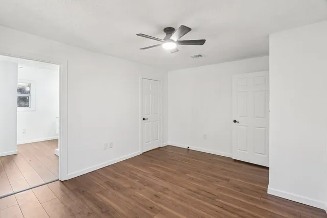 a view of a room with wooden floor