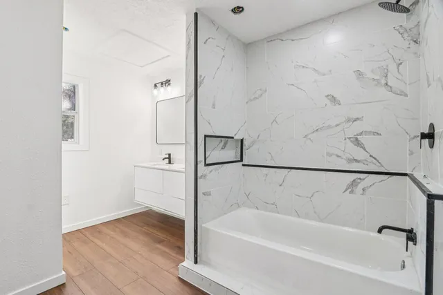 a bathroom with a bathtub and a shower