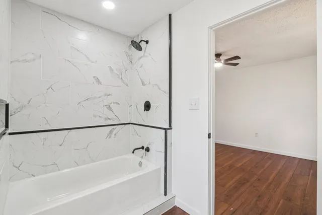 a bathroom with a bathtub and shower