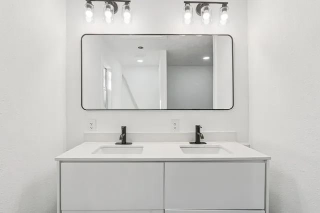 a bathroom with a sink and a mirror