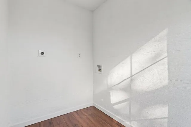 a view of a room with wooden floor