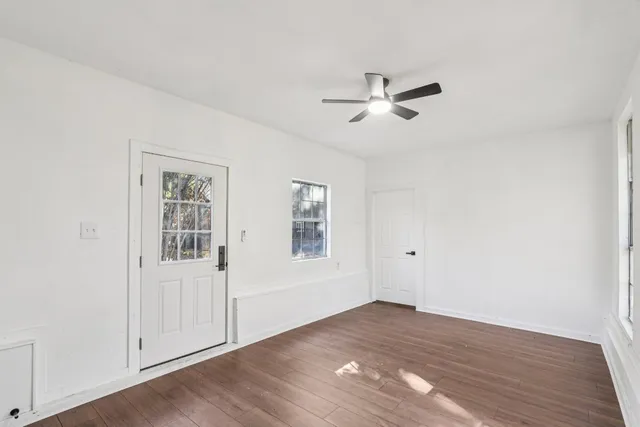 wooden floor in an empty room with a window