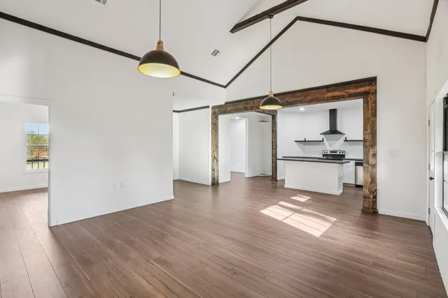 a view of a kitchen with a dishwasher and wooden floor
