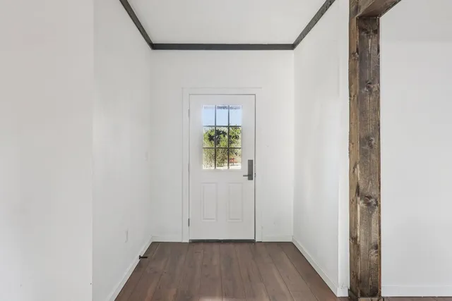 a view of an entryway with wooden floor