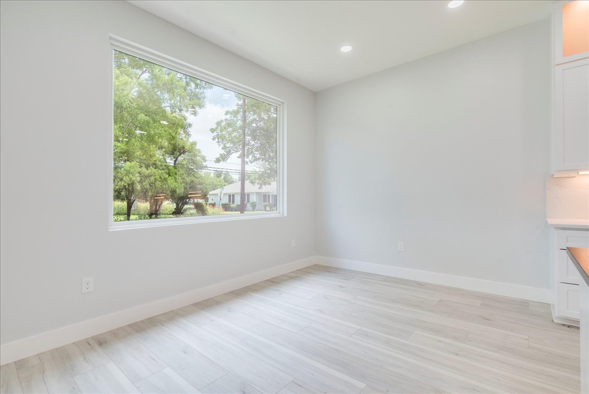 1215 Howard Street Taylor, TX 76574 - Photo 10 of 37 an empty room with wooden floor and windows