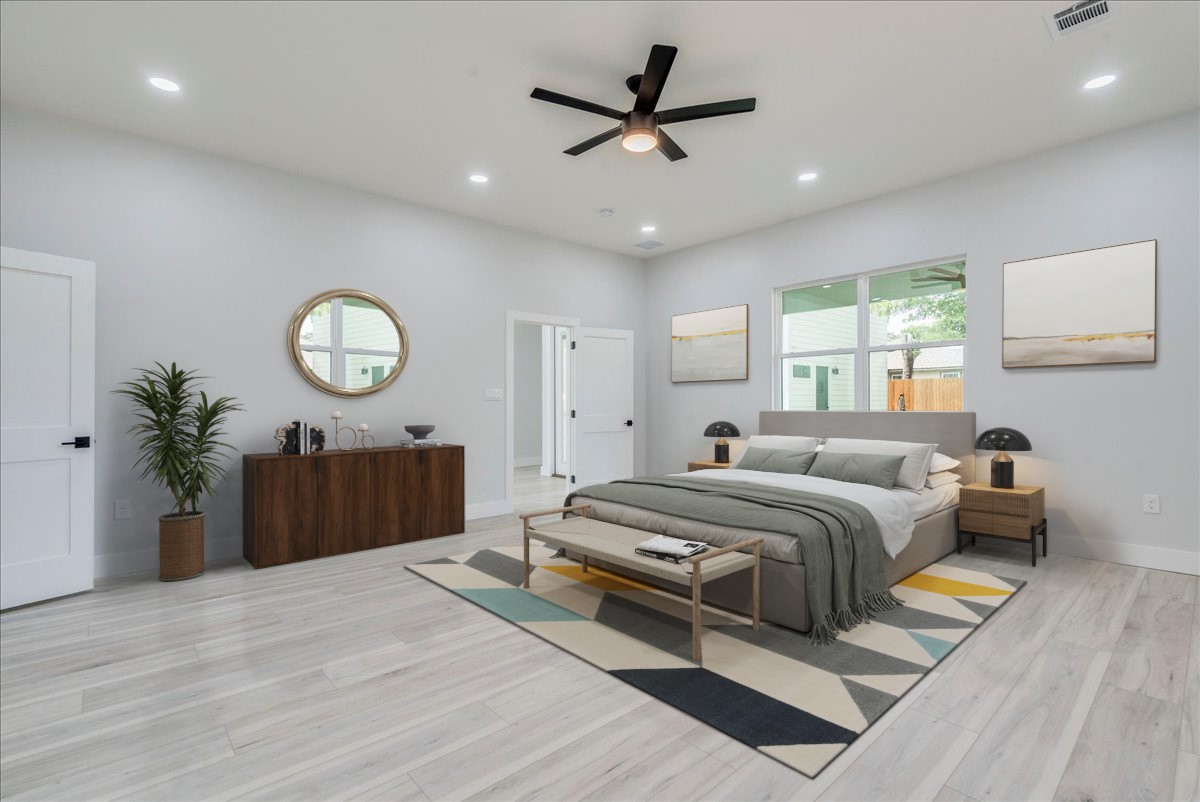 1215 Howard Street Taylor, TX 76574 - Photo 11 of 37 a bedroom with a large bed and a chandelier
