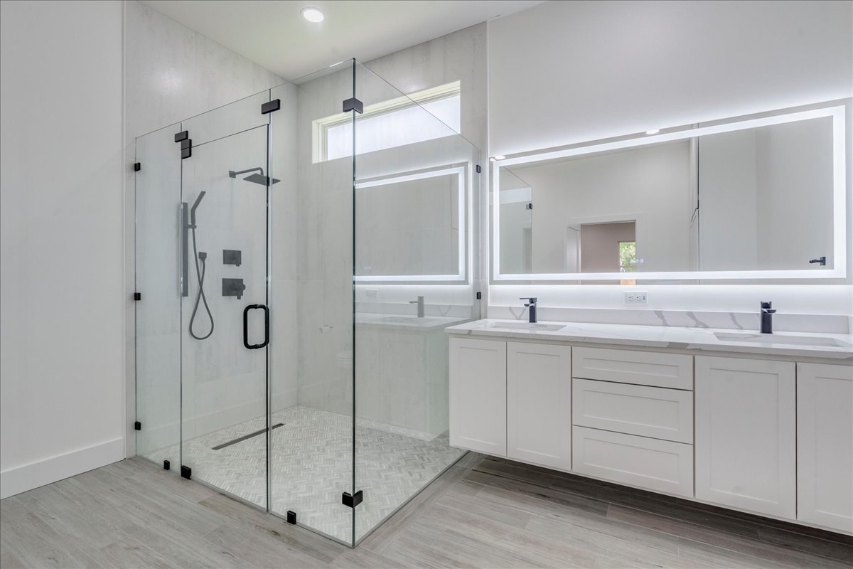 1215 Howard Street Taylor, TX 76574 - Photo 14 of 37 a bathroom with a shower sink and mirror