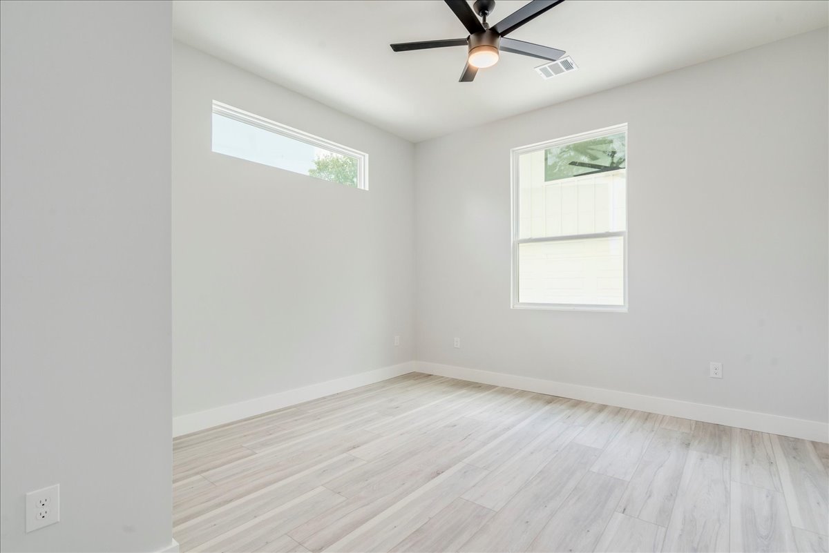 1215 Howard Street Taylor, TX 76574 - Photo 17 of 37 wooden floor in an empty room with a window