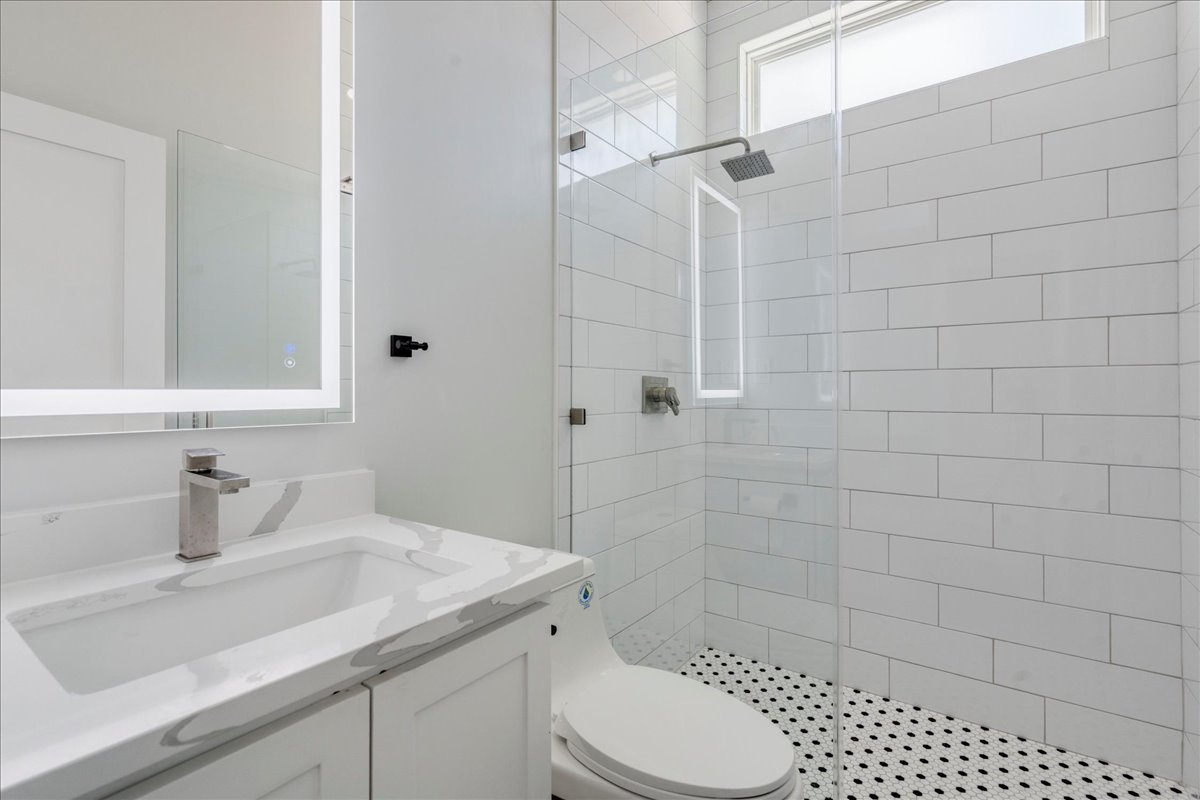 1215 Howard Street Taylor, TX 76574 - Photo 18 of 37 a bathroom with a sink toilet and shower