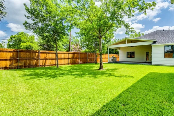 a view of a patio with couches chairs and a swimming pool