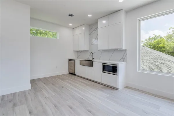 a kitchen with stainless steel appliances a refrigerator and a stove top oven