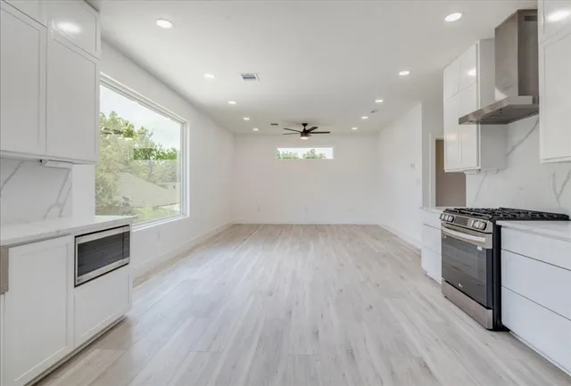 a view of a kitchen with a sink cabinets and a window