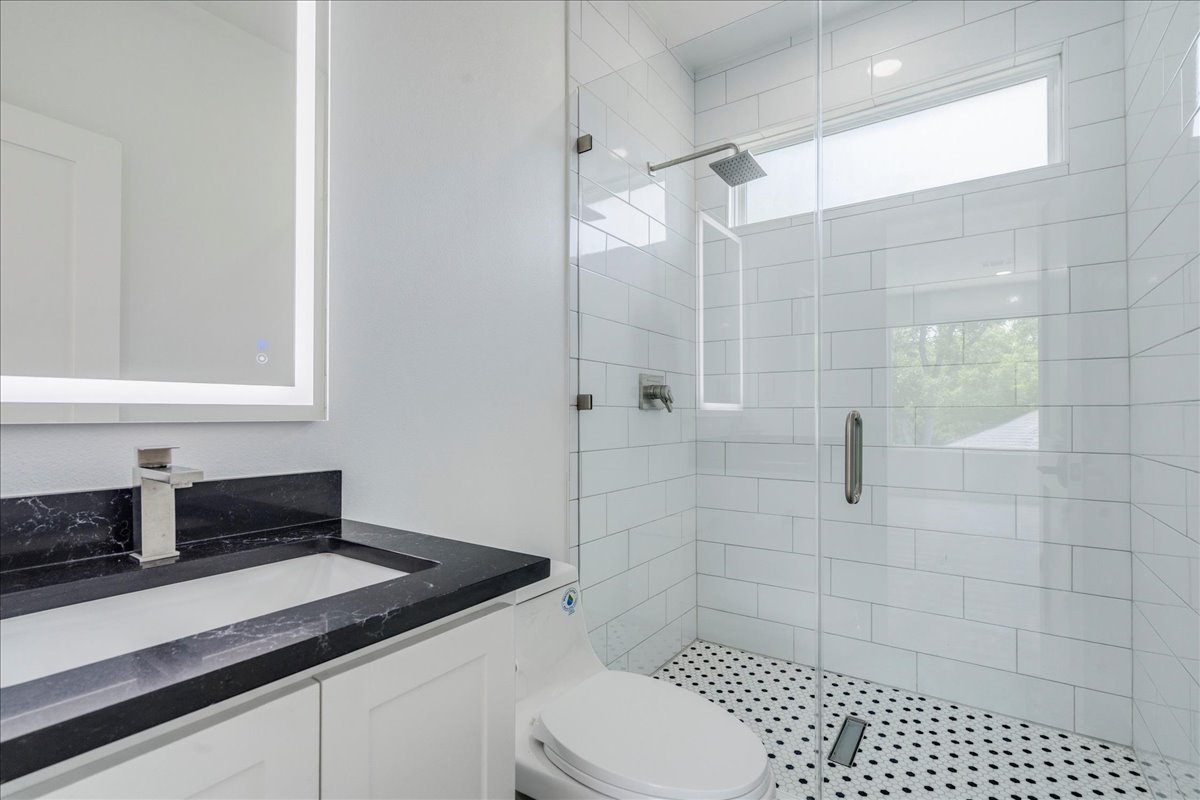 1215 Howard Street Taylor, TX 76574 - Photo 31 of 37 a bathroom with a sink a toilet and shower