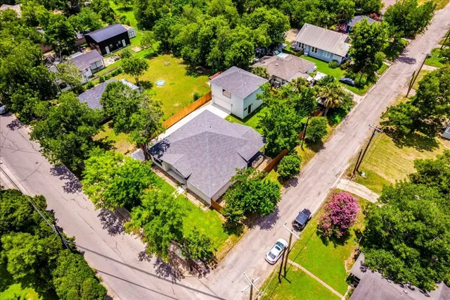 an aerial view of a house with a yard and swimming pool
