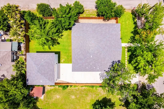 an aerial view of a house with a yard