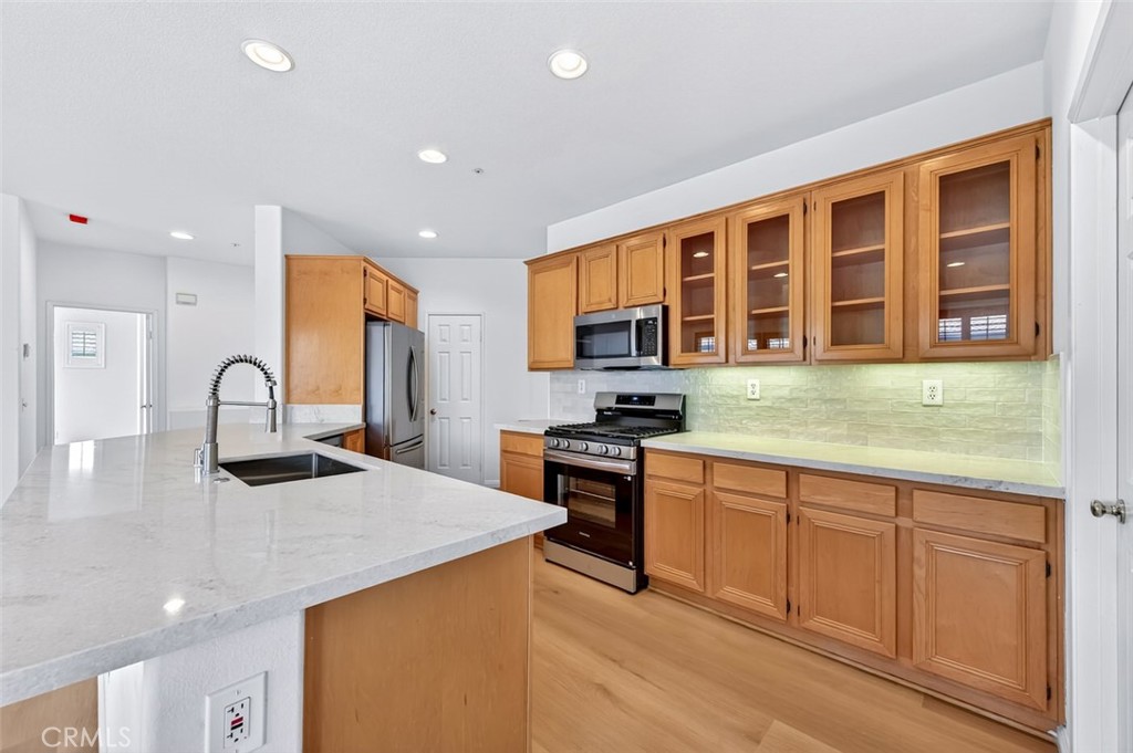 447 Ridgeway Irvine, CA 92620 - Photo 23 of 88 a kitchen with stainless steel appliances granite countertop a sink and cabinets