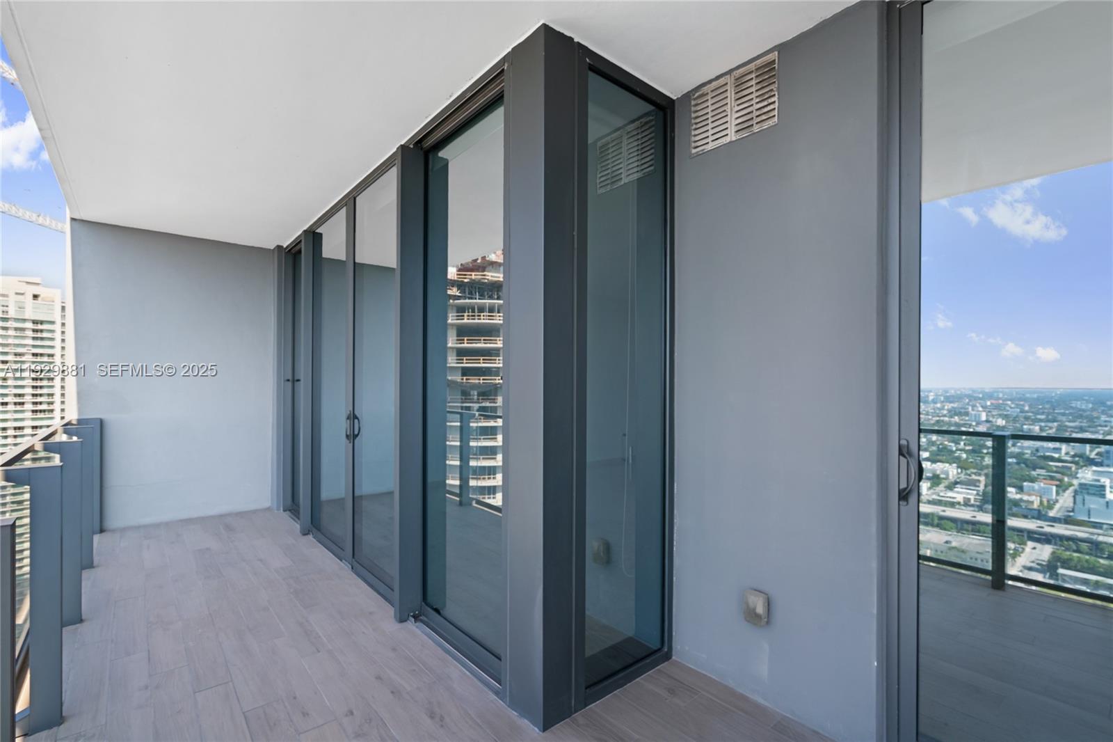 88 Southwest 7th Street, Unit 3608 Miami, FL 33130 - Photo 16 of 36 a view of hallway with window and wooden floor